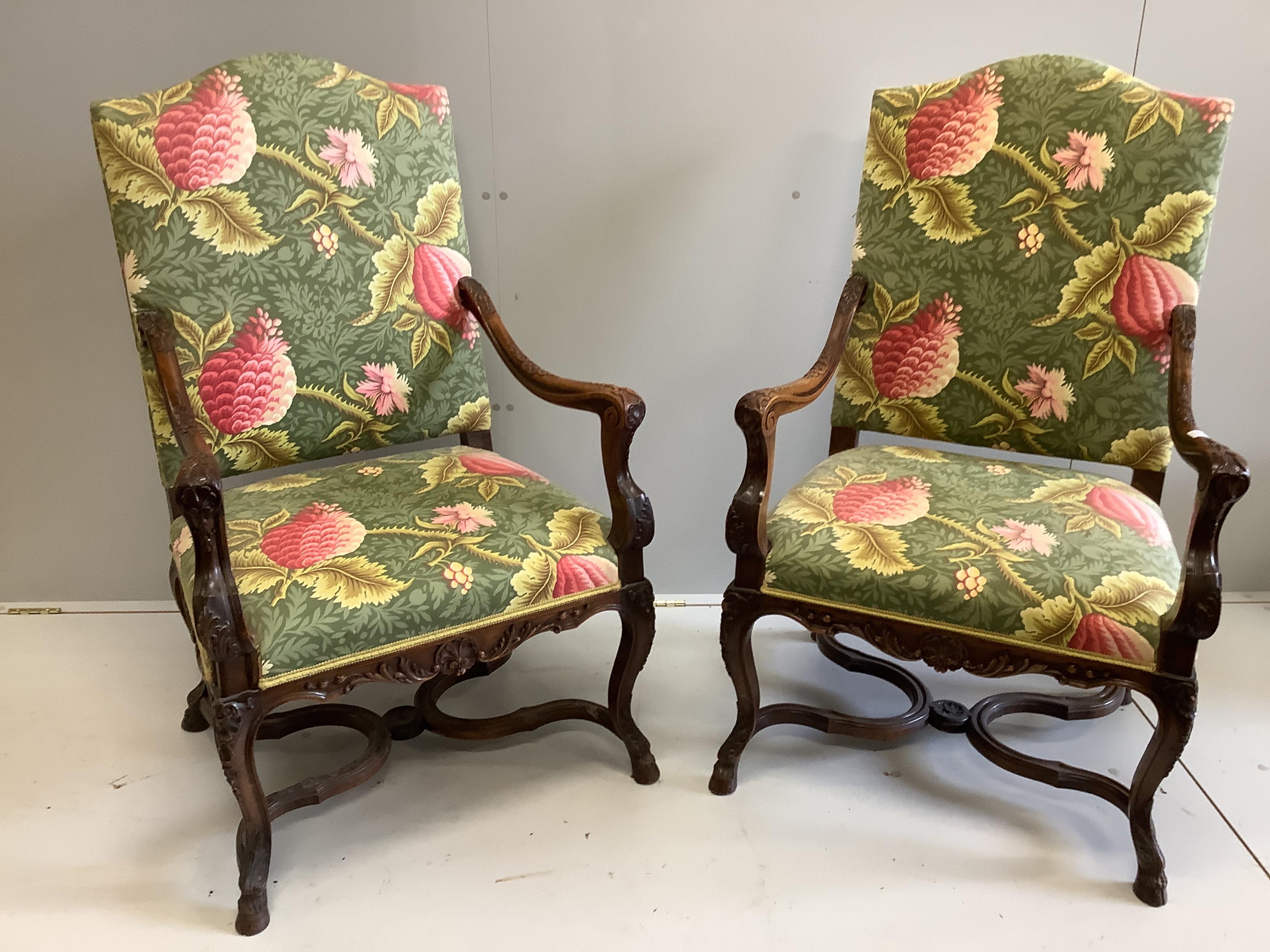 A pair of 18th century style French walnut elbow chairs, width 70cm, depth 60cm, height 116cm